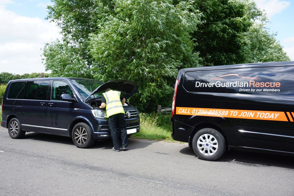 A Driver Guardian Agent Fixing A Camper Van 